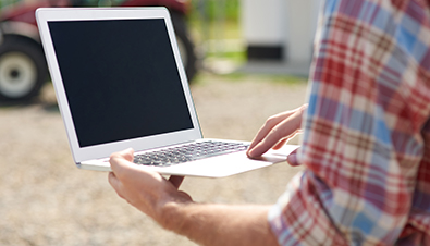 Person with laptop in field